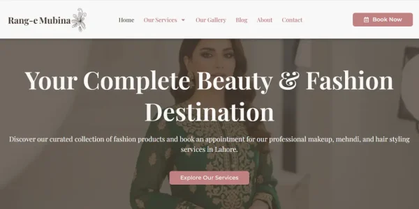 A high-resolution, professional mockup of the 'Rang e Mubina' fashion website. The website's elegant homepage (featuring soft pinks, high-fashion models, and makeup artistry) is displayed on a modern, sleek laptop screen. The laptop is set against a clean, softly blurred studio background that complements the brand's sophisticated style.